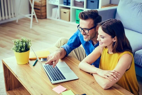 a couple looking at mortgage rates in their computer