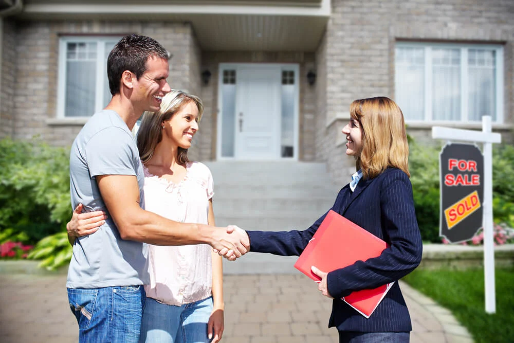 couple receiving home from realtor